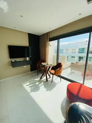 a living room with a table and chairs and a large window at Atlantic Suite View 2 in Casablanca