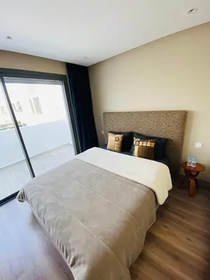 a bedroom with a large bed and a large window at Atlantic Suite View 2 in Casablanca
