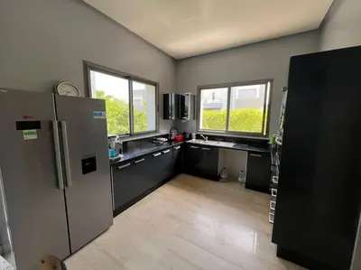 a kitchen with stainless steel appliances and windows at Villa de Luxe piscine privée in Casablanca