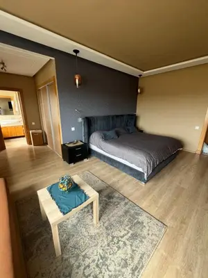 a bedroom with a bed and a table in it at Villa de Luxe piscine privée in Casablanca
