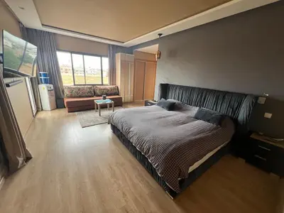 a bedroom with a large bed and a couch at Villa de Luxe piscine privée in Casablanca