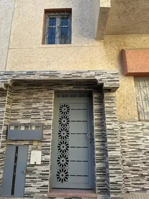 a door on the side of a building at Jolie Appt à skhirat 5min de la plage par voiture in Skhirat