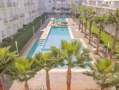 an overhead view of a swimming pool with palm trees at Shems Bouznika kettani in Bouznika