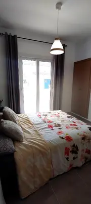 a bedroom with a large bed with a large window at Sublime Appart Bouznika Pool&View in Bouznika