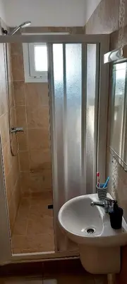 a bathroom with a shower and a sink at Sublime Appart Bouznika Pool&View in Bouznika