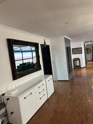 a living room with a large mirror on the wall at Appartement loft de luxe dans un quartier Art Déco en plein centre de Casablanca in Casablanca