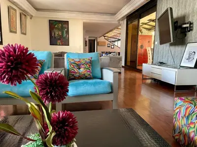 a living room with a couch and a table at Appartement loft de luxe dans un quartier Art Déco en plein centre de Casablanca in Casablanca