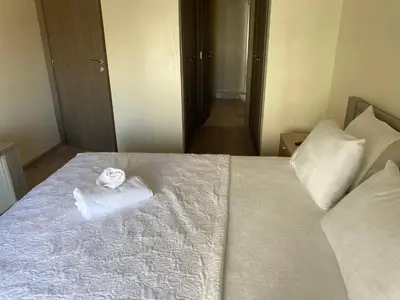 a room with a bed with a folded towel on it at Parc Nouaceur in Nouaseur