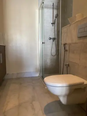 a bathroom with a shower and a toilet in it at Parc Nouaceur in Nouaseur
