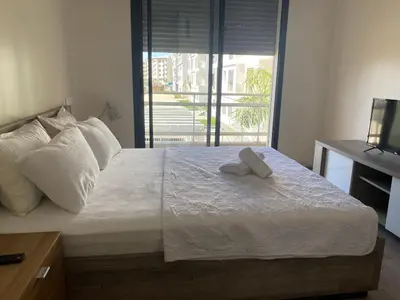 a bedroom with a bed with two towels on it at Parc Nouaceur in Nouaseur