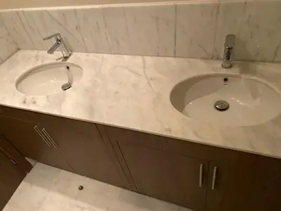 a bathroom with a white sink and brown cabinets at Parc Nouaceur in Nouaseur