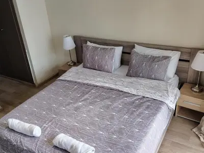 a bedroom with a large bed with purple sheets and pillows at Parc Nouaceur in Nouaseur