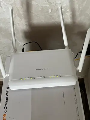 a white router sitting on top of a box at Appartement Dar Bouazza Tamaris Casablanca Airport AquaParc Fibre Orange Wifi Parking Security in Dar Bouazza