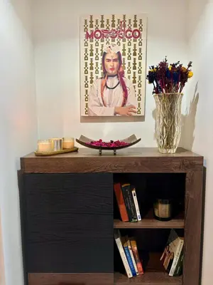 a book shelf with a picture of a guru on it at Au centre de Casablanca maarif in Casablanca