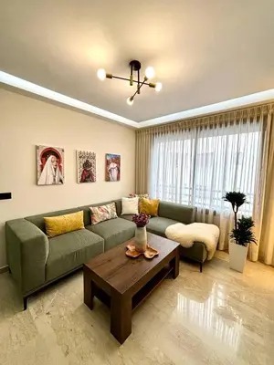 a living room with a green couch and a coffee table at Au centre de Casablanca maarif in Casablanca