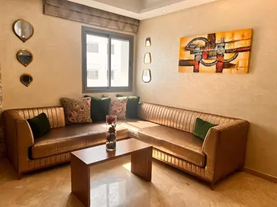 a living room with two couches and a table at Studio Cosy Centre Ville Casablanca in Casablanca