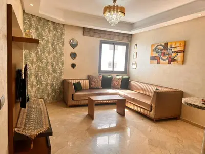 a living room with a couch and a table at Studio Cosy Centre Ville Casablanca in Casablanca