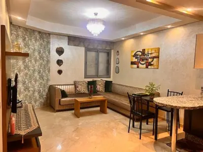 a living room with a couch and a table at Studio Cosy Centre Ville Casablanca in Casablanca