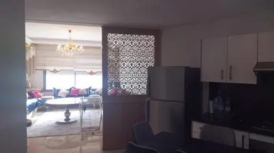 a kitchen and a living room with a refrigerator at Résidence Mansbay Rosa, Mohammedia in Mohammedia
