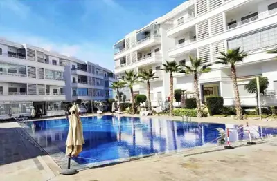 a large swimming pool in front of a building at Résidence Mansbay Rosa, Mohammedia in Mohammedia