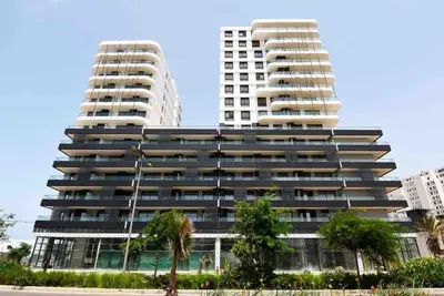 two tall buildings with palm trees in front of them at Tour 33 : Appartement chic en plein cœur de Casa in Casablanca