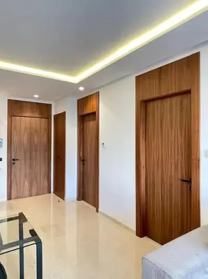a room with two wooden doors and a glass table at Tour 33 : Appartement chic en plein cœur de Casa in Casablanca