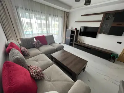 a living room with a couch and a coffee table at ZS house harhoura vue sur piscine in Temara