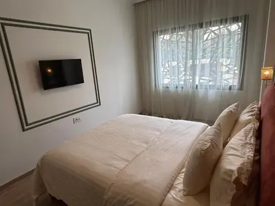 a bedroom with a bed and a mirror and a window at Studio cosy chic in Casablanca