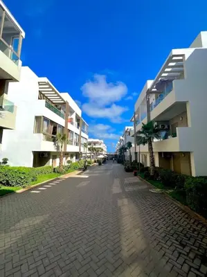an empty street next to some apartment buildings at Heaven Beach SIDI RAHAL in Sidi Rahal