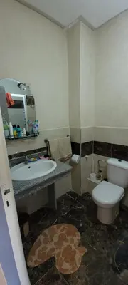 a bathroom with a toilet and a sink at Bel appartement avec vue sur mer Sidi Rahal in Sidi Rahal
