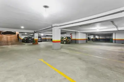 an empty parking garage with cars parked in it at Serene One Bed Oasis in the Heart Of The Medina in Les Camps