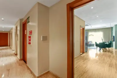 a hallway with a door leading to a living room at Serene One Bed Oasis in the Heart Of The Medina in Les Camps