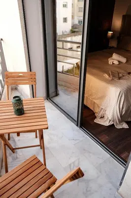 a room with a table and a bed and a window at New Apartment Casablanca City Center Maarif in Casablanca