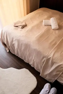 a bed with two towels and two rugs on it at New Apartment Casablanca City Center Maarif in Casablanca