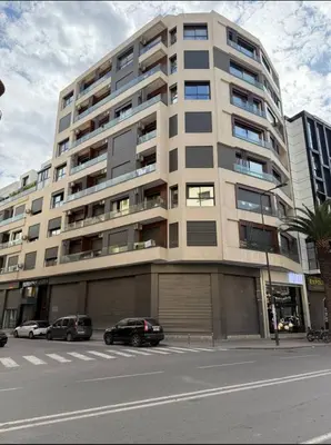 a large apartment building with cars parked in front of it at New Apartment Casablanca City Center Maarif in Casablanca