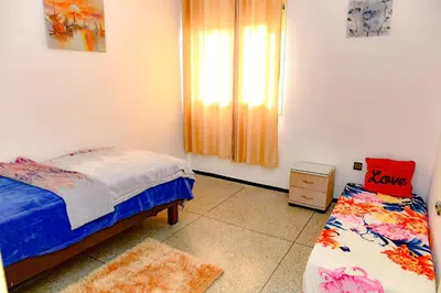 a small bedroom with a bed and a window at Dar Lamine Duplex in Rabat