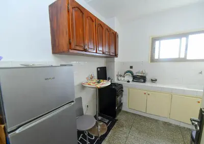 a small kitchen with a refrigerator and a counter at Dar Lamine Duplex in Rabat