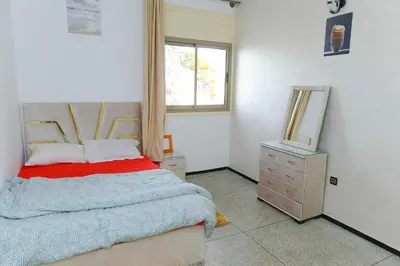 a bedroom with a bed and a mirror and a dresser at Dar Lamine Duplex in Rabat