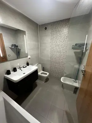 a bathroom with a sink and a toilet at Appartement confortable au corniche in Mohammedia
