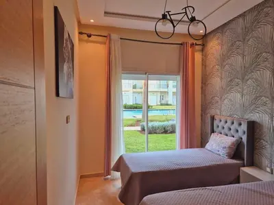 a bedroom with a bed and a window at CASA BAY BEACH OMK 3 in Sidi Rahal