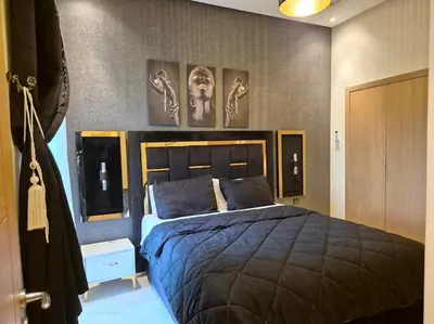 a bedroom with a bed and pictures on the wall at CASA BAY BEACH OMK 3 in Sidi Rahal