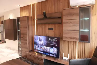a living room with a tv on a wooden wall at LUXE APPARTEMENT in Casablanca