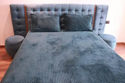 a bed with a black headboard and two pillows at LUXE APPARTEMENT in Casablanca