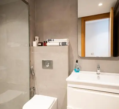 a bathroom with a toilet and a sink and a shower at Two bedrooms sunny appartement in ain diab in Casablanca