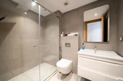 a bathroom with a shower and a toilet and a sink at Two bedrooms sunny appartement in ain diab in Casablanca