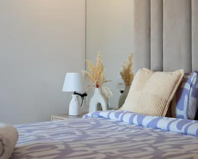a bedroom with a bed with a couch and a lamp at Two bedrooms sunny appartement in ain diab in Casablanca