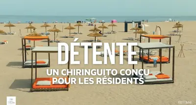 a beach with tables and chairs and umbrellas at Appartement moderne CASABAY BEACH Sidi Rahal in Sidi Rahal