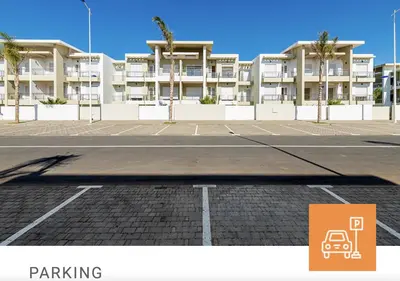 an empty parking lot in front of a building at Appartement moderne CASABAY BEACH Sidi Rahal in Sidi Rahal