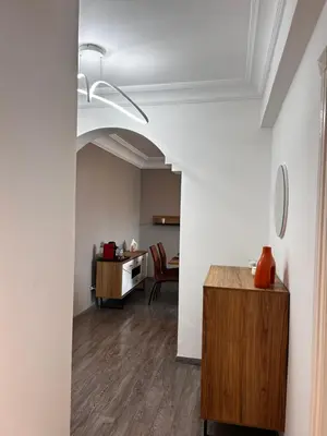 a room with white walls and a table and chairs at 3 minutes de casa voyageurs in Casablanca