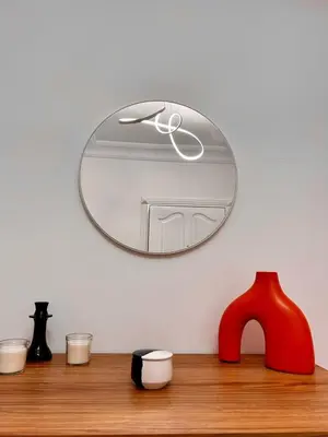 a mirror on a wall above a wooden shelf at 3 minutes de casa voyageurs in Casablanca
